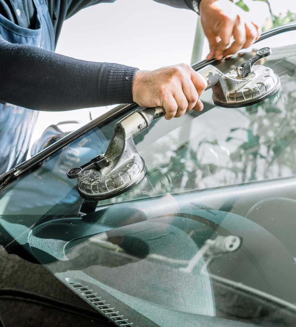 technician replacing windshield glass