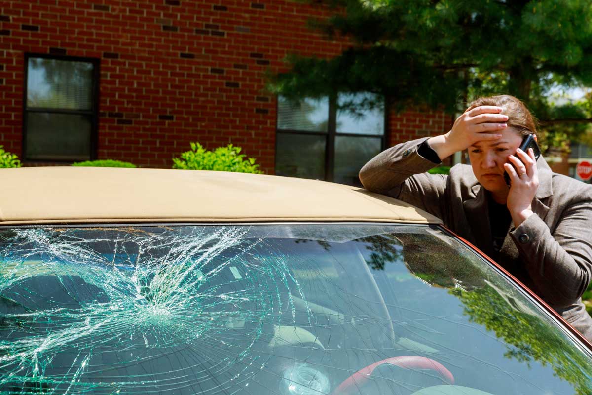 a car driver calling for assistance with their broken windshield